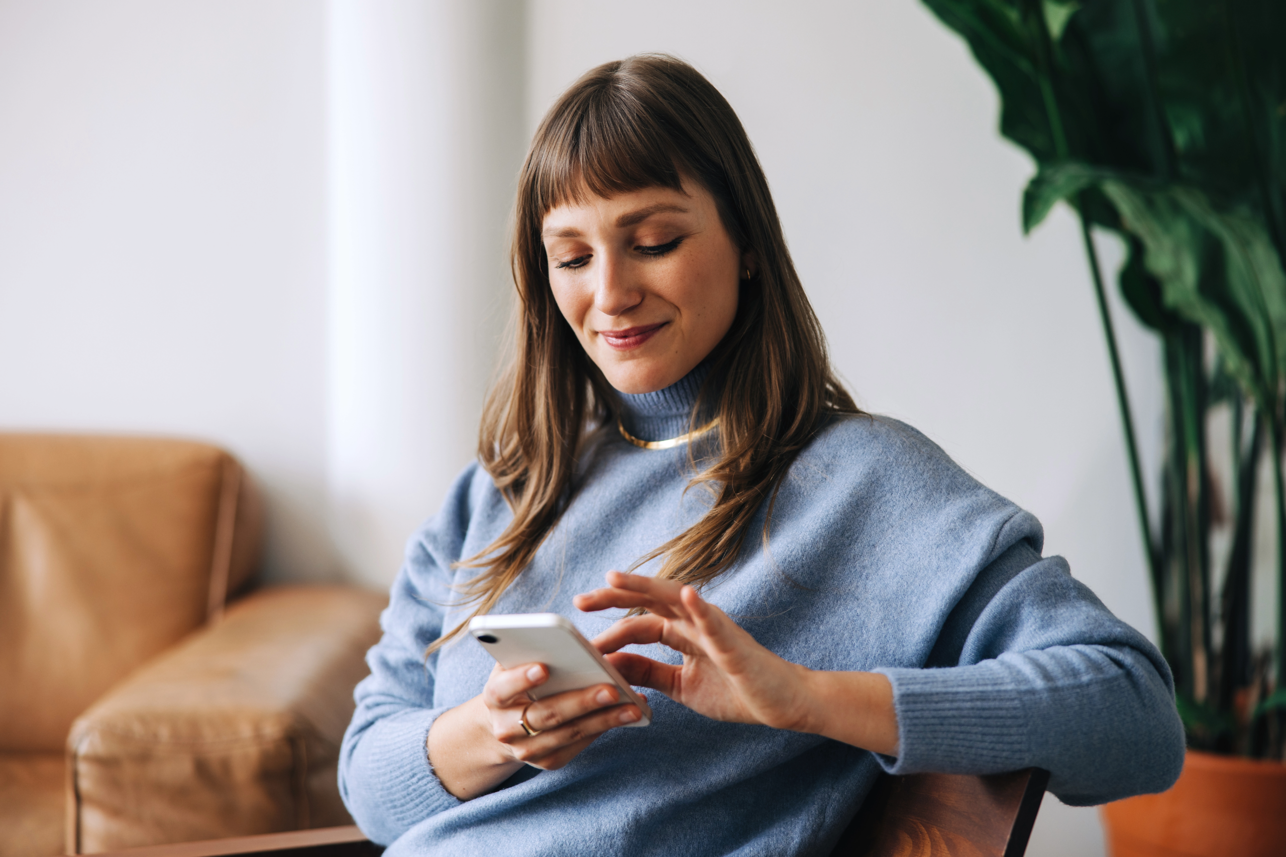 A woman on the phone scrolling and texting
